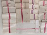a lot of white and red napkins on a table