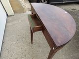 a small desk with a drawer on top of it