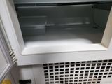 a white refrigerator with a door open on a tile floor