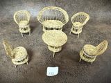 Plusieurs chaises et tables en osier sont disposées en cercle, avec une étiquette de prix