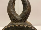 a sculpture of a horned head with horns on it