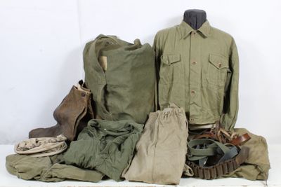 a pile of military clothing on a white table