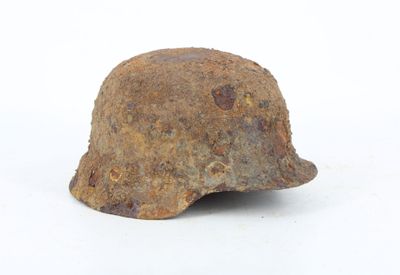 a rusty helmet on a white surface