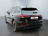 the rear end of a black audi qx parked in a showroom