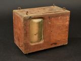 a small wooden box with a clock inside of it