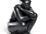 sculpture noire représentant un homme assis à genoux, les mains posées sur les genoux