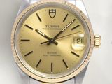 a close up of a watch with a gold dial