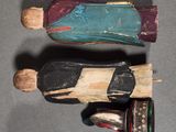 two wooden figurines of a man and a woman on a table