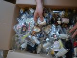 a person holding a box full of assorted toys