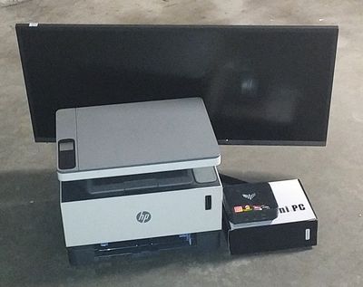 an image of a printer and a monitor on the floor
