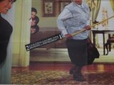 movie poster of a woman holding a broom in front of a man
