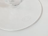 a glass of water sitting on top of a glass plate
