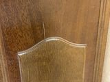 an image of a wooden cabinet with a metal door