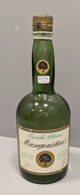 a bottle of liquor sitting on a table next to a bottle of liquor