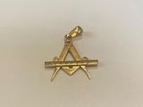 a close up of a gold masonic symbol on a white surface
