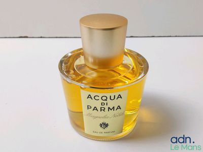 a close up of a bottle of perfume on a table
