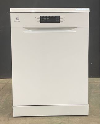 an image of a white dishwasher sitting on top of a tiled floor