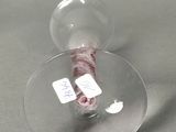 a wine glass that has a wine bottle inside of it