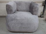 a grey chair that is sitting in a garage