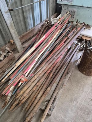 a pile of old skis and ski poles in a room