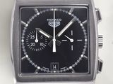 a close up of a watch with a black face