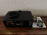 a canon printer sitting on top of a wooden table
