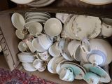 a box full of tea cups and saucers on a table