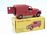 a red toy truck sitting on top of a yellow box