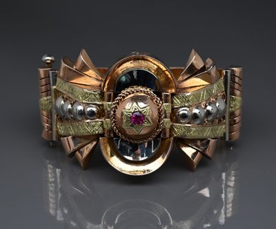 a close up of a bracelet with a clock on it