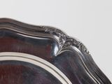 a close up of a silver plate on a table