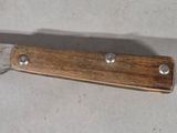 a knife with a wooden handle on a table