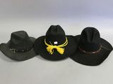 three hats are lined up in a row on a white surface