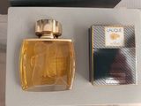 an image of a bottle of perfume next to a box of perfume