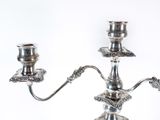 a silver candelab with two candles on it