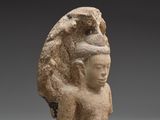 a stone head of a woman with a bird on her head