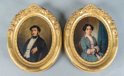 pair of portraits of a man and a woman in a gold frame