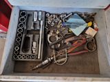 a box full of tools that are sitting on the floor