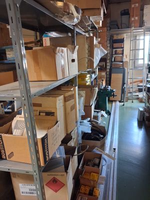 boxes are stacked on a shelf in a room with a ladder