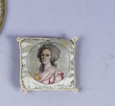 a small picture of a woman on a pillow