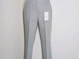 grey pants on a mannequin stand against a white wall