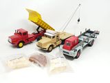 three toy trucks and a dump truck in the picture