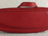 a red purse sitting on top of a white table
