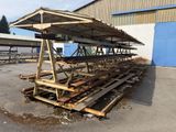 a wooden structure that is sitting in the middle of a parking lot