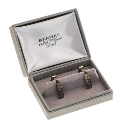 two silver cuff rings in a box on a white background