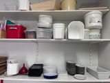 many dishes and containers on the shelves in the kitchen