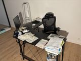 a desk with a chair and a computer on top of it