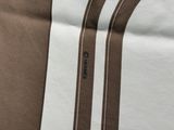 a close up of a brown and white striped bed spread