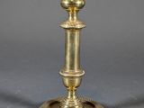 pair of antique brass candlesticks on a grey background