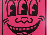 pink and black drawing of a smiling face on a pink background