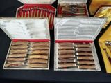 a lot of silverware in a box on a table